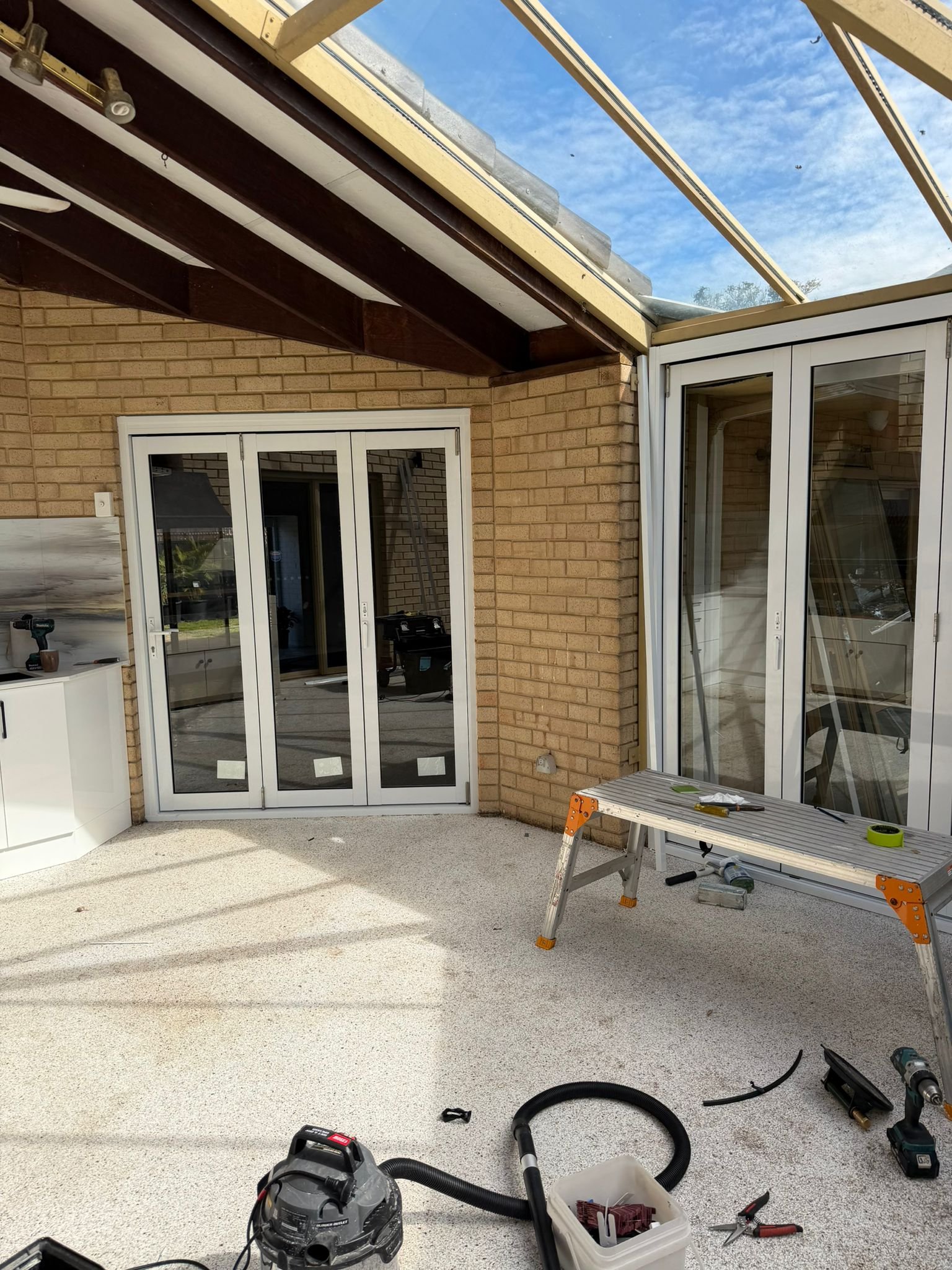 New aluminium-framed glass enclosure installed around a Perth patio